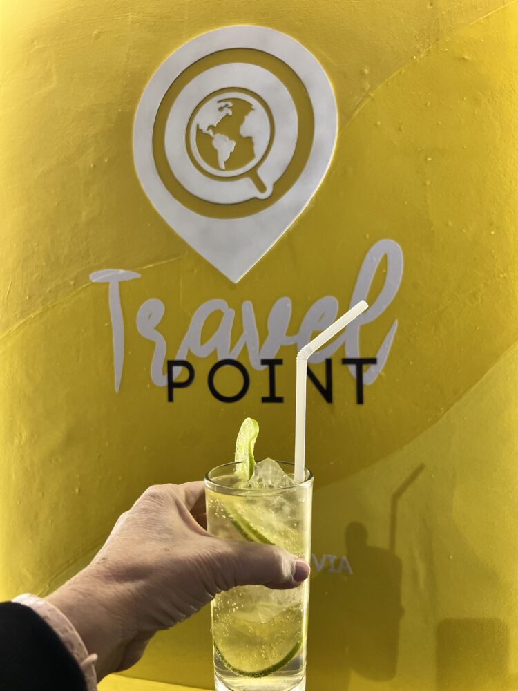 Traditional Bolivian Foods to Try | The Common Traveler | image: hand holding glass of chuflay cocktail