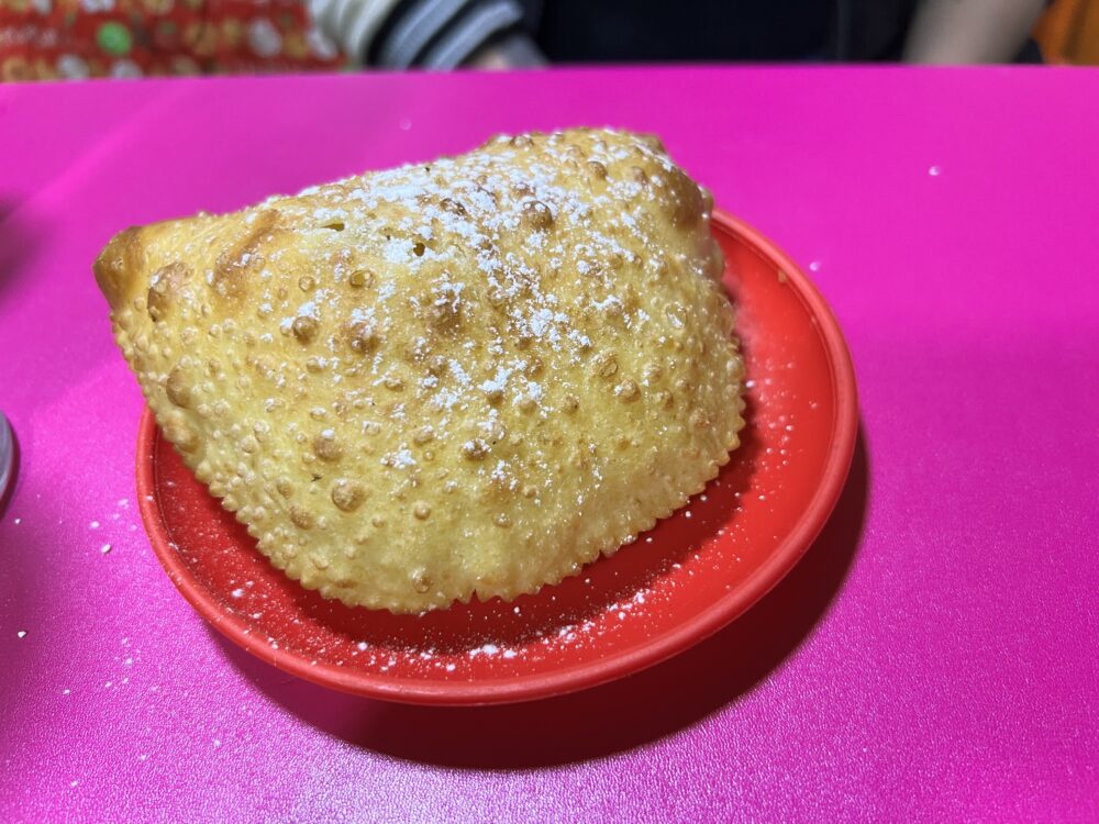 Traditional Bolivian Foods to Try | The Common Traveler | image: cheese pastel topped with sugar