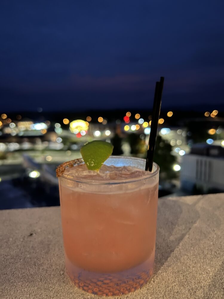Best Things to Do in Bristol TN/VA | The Common Traveler | image: cocktail with view of Bristol sign in background at night