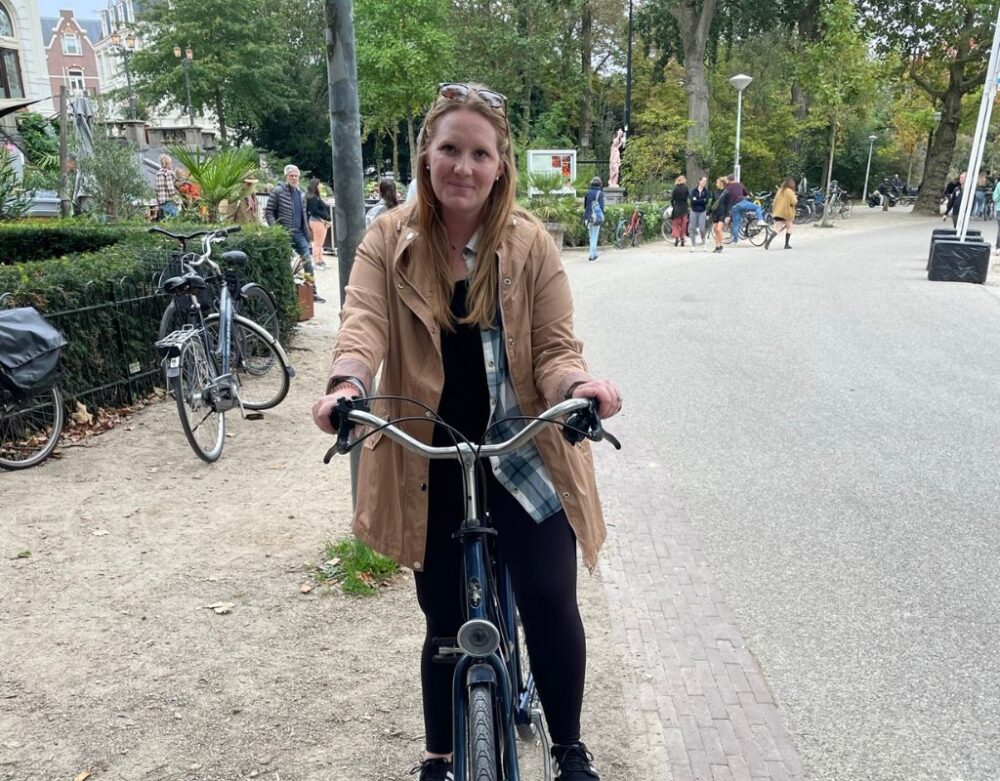 7 Best Day Trips From Amsterdam | The Common Traveler | image: woman on bike along Northern Canal