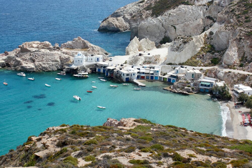 Island Hopping Beyond Santorini | The Common Traveler | image: boats in port in Milos