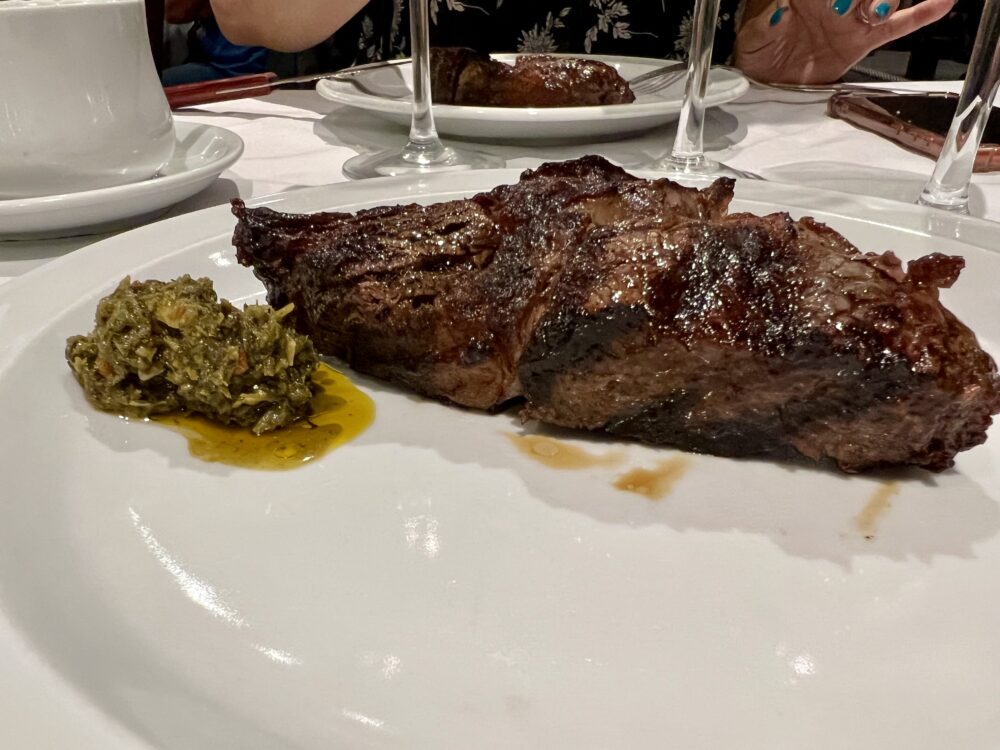 Best Foods and Drinks to Try in Argentina | The Common Traveler | image: steak with chimichurri on white plate