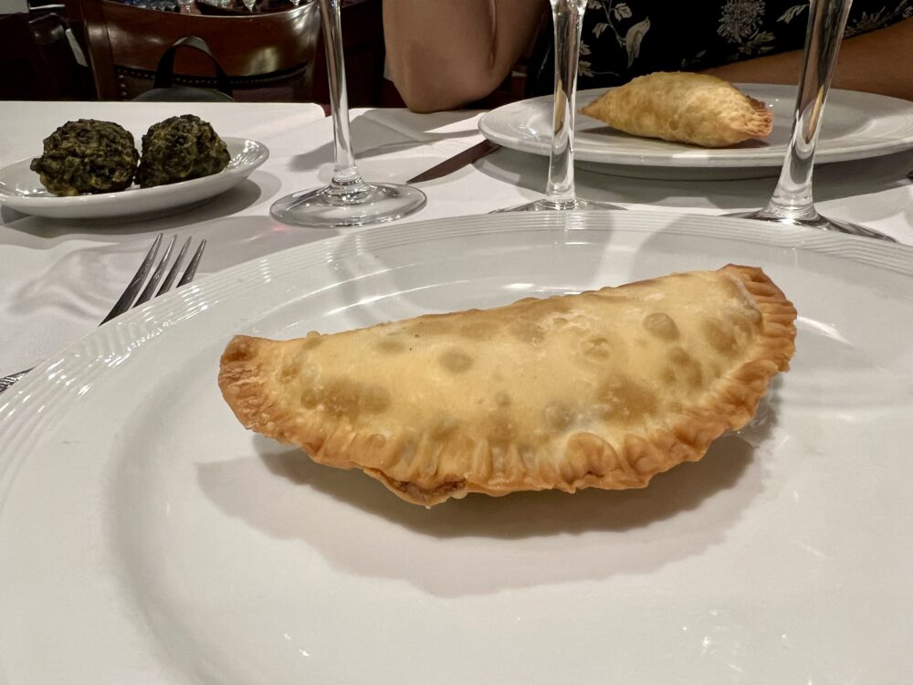 Best Foods and Drinks to Try in Argentina | The Common Traveler | image: empanada on white plate