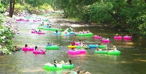 28 Best Things to Do in Helen, GA | The Common Traveler | image: pink, green, and blue tubes on river