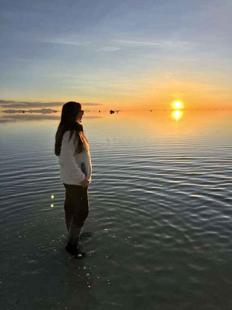 Guide to La Paz, Bolivia | The Common Traveler | image: woman standing on Salar de Uyuni at sunset
