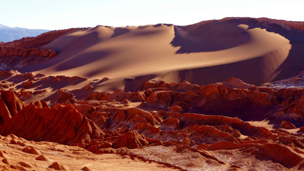 San Pedro de Atacama | The Common Traveler | image: Valle de la Muerte - red rocks and sand dunes