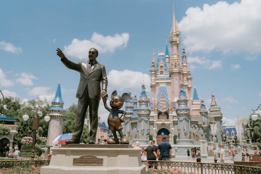 Money Saving Tips for Family Adventures | The Common Traveler | image: Walt Disney and Mickey statue in front of Cinderella Castle