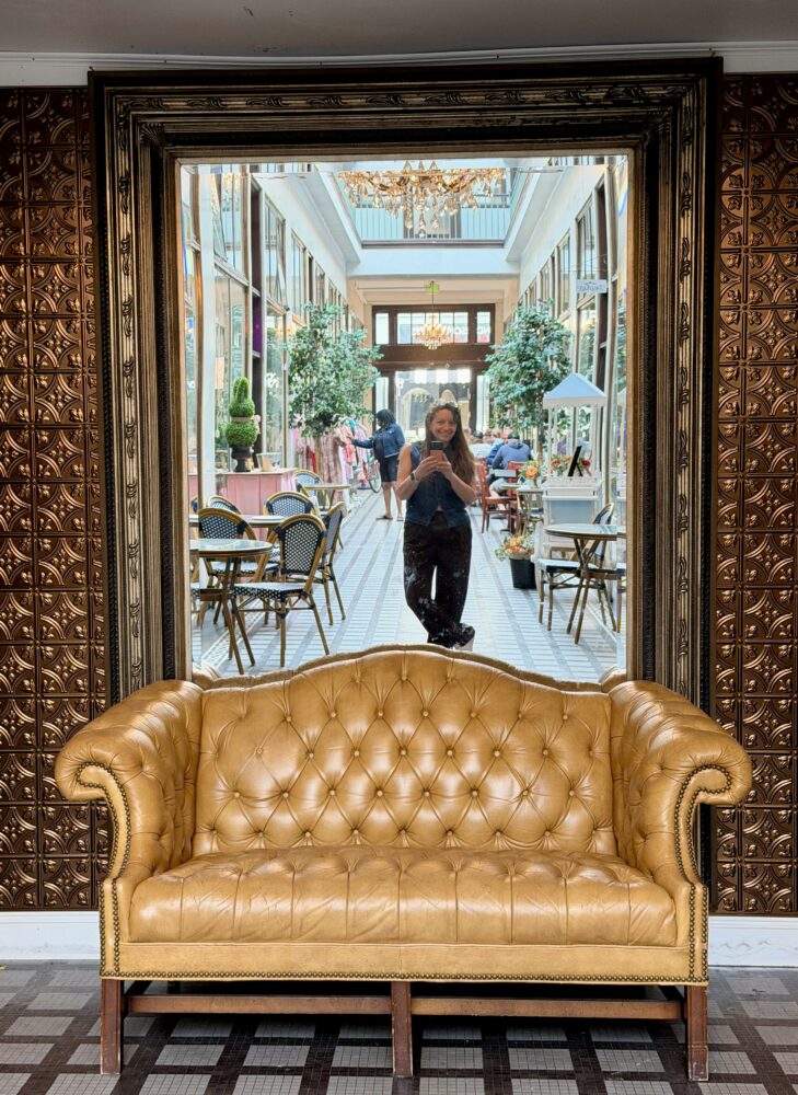 Elizabeth City, NC: The Hidden Gem You've Been Driving Past (and Shouldn't) | The Common Traveler | image: woman reflected in mirror with tan sofa