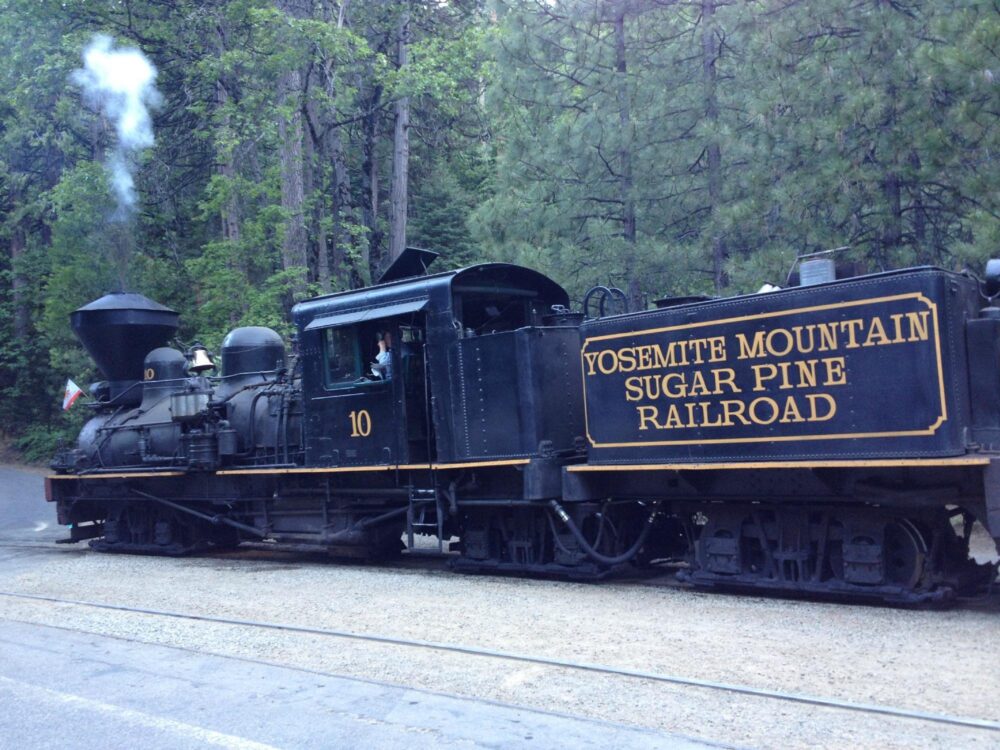 Best Scenic Steam Train Rides in America | The Common Traveler | image: black locomotive of the Yosemite Mountain Sugar Pine Railroad