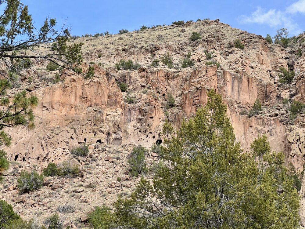 Bandelier National Monument is Amazing | The Common Traveler | image: side of mountain with holes for cliff dwellings