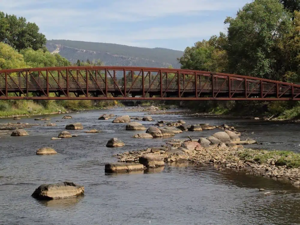 Durango, Colorado: Your Complete Guide | The Common Traveler | image: brown bridge and crosswalk over Animas River