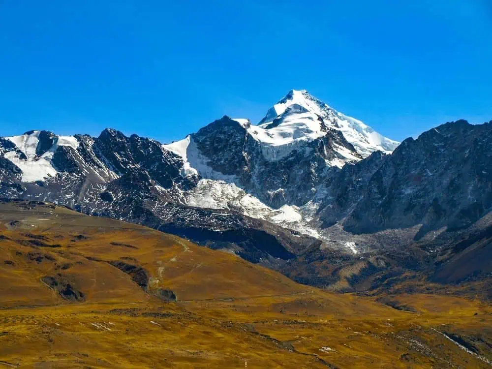 Gringo Trail in Bolivia: 5 Places to Escape the Usual Tourist Route | The Common Traveler | image: snow covered peaks of Huayna Potosi