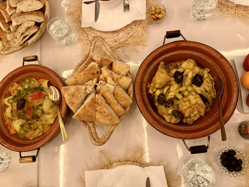 Why December Might Be the Best Time to Visit Marrakech | The Common Traveler | image: dishes of fresh bread, tanginess, and vegetables in clay pots.