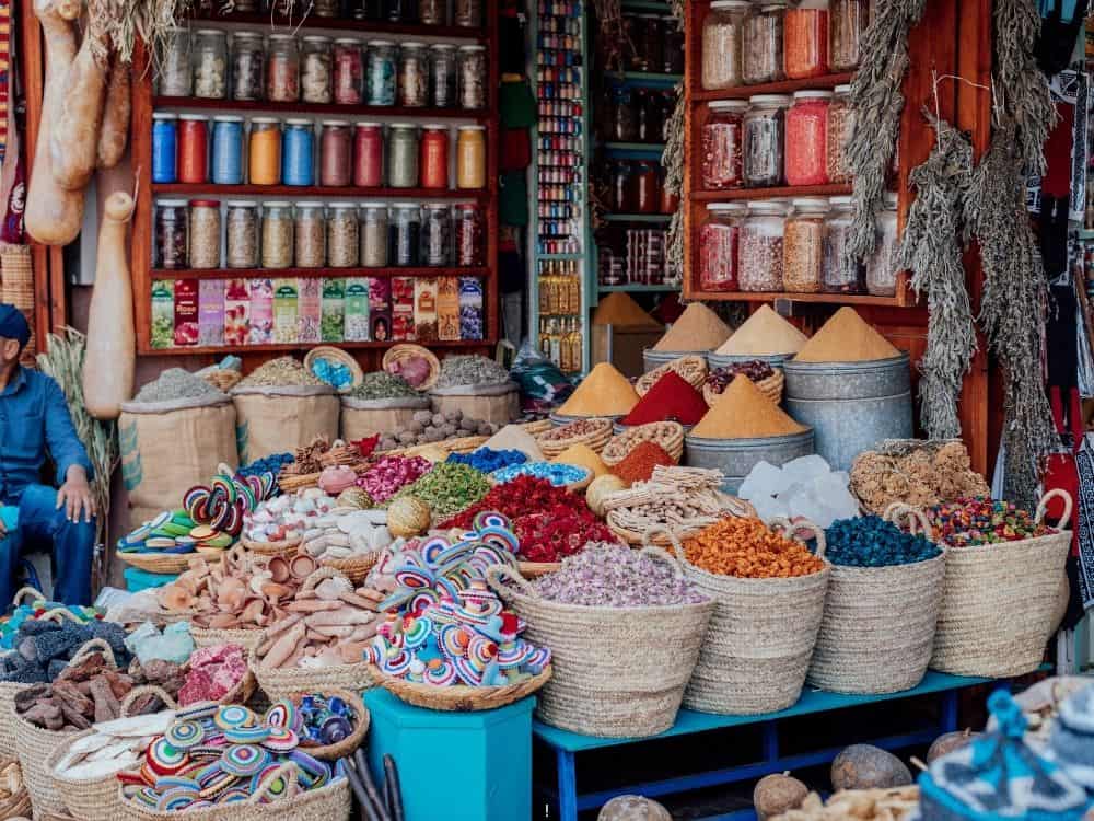Why December Might Be the Best Time to Visit Marrakech | The Common Traveler | image: baskets full of colorful products at Medina